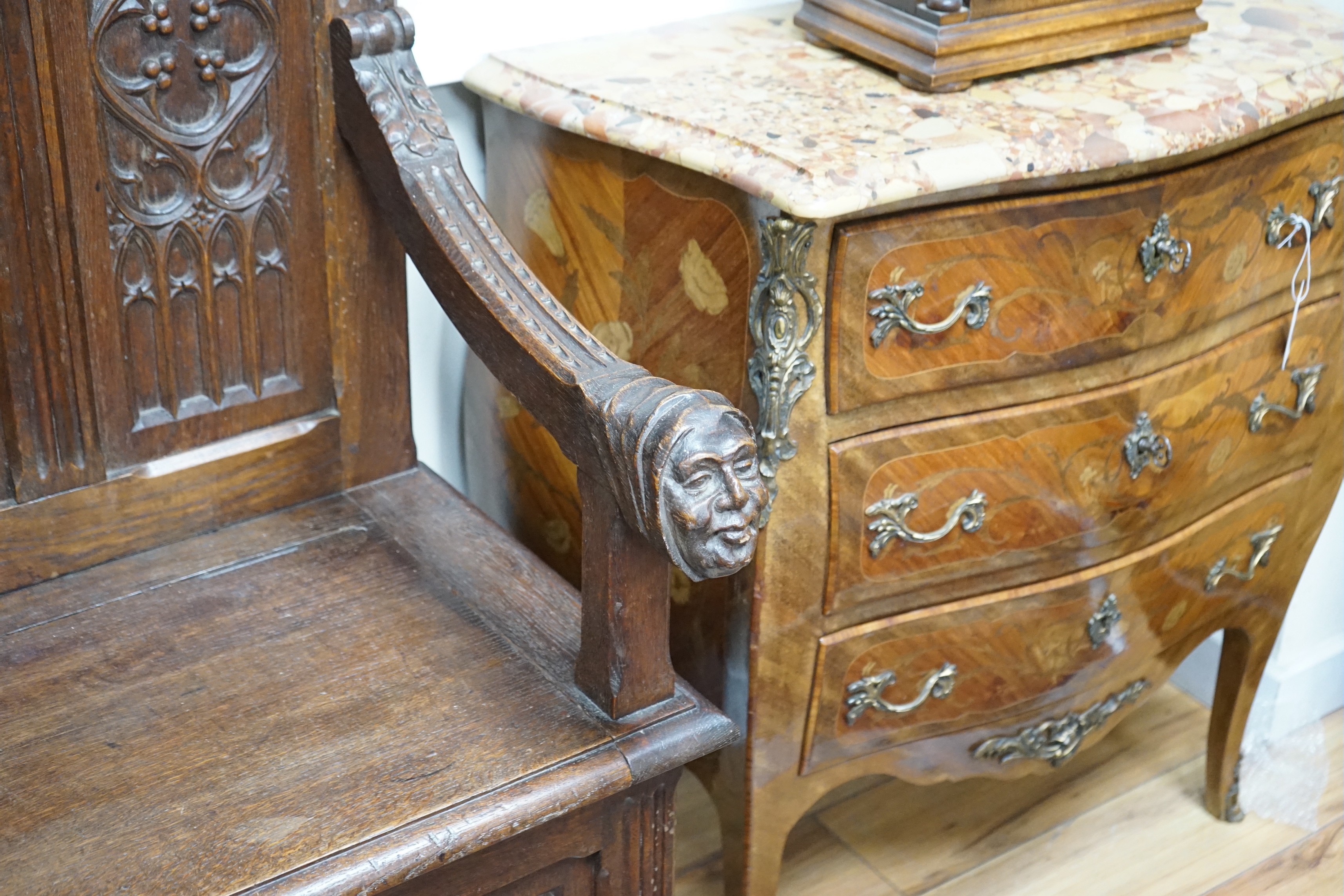 An early 20th century Gothic style carved oak box seat settle, length 116cm, depth 45cm, height 154cm